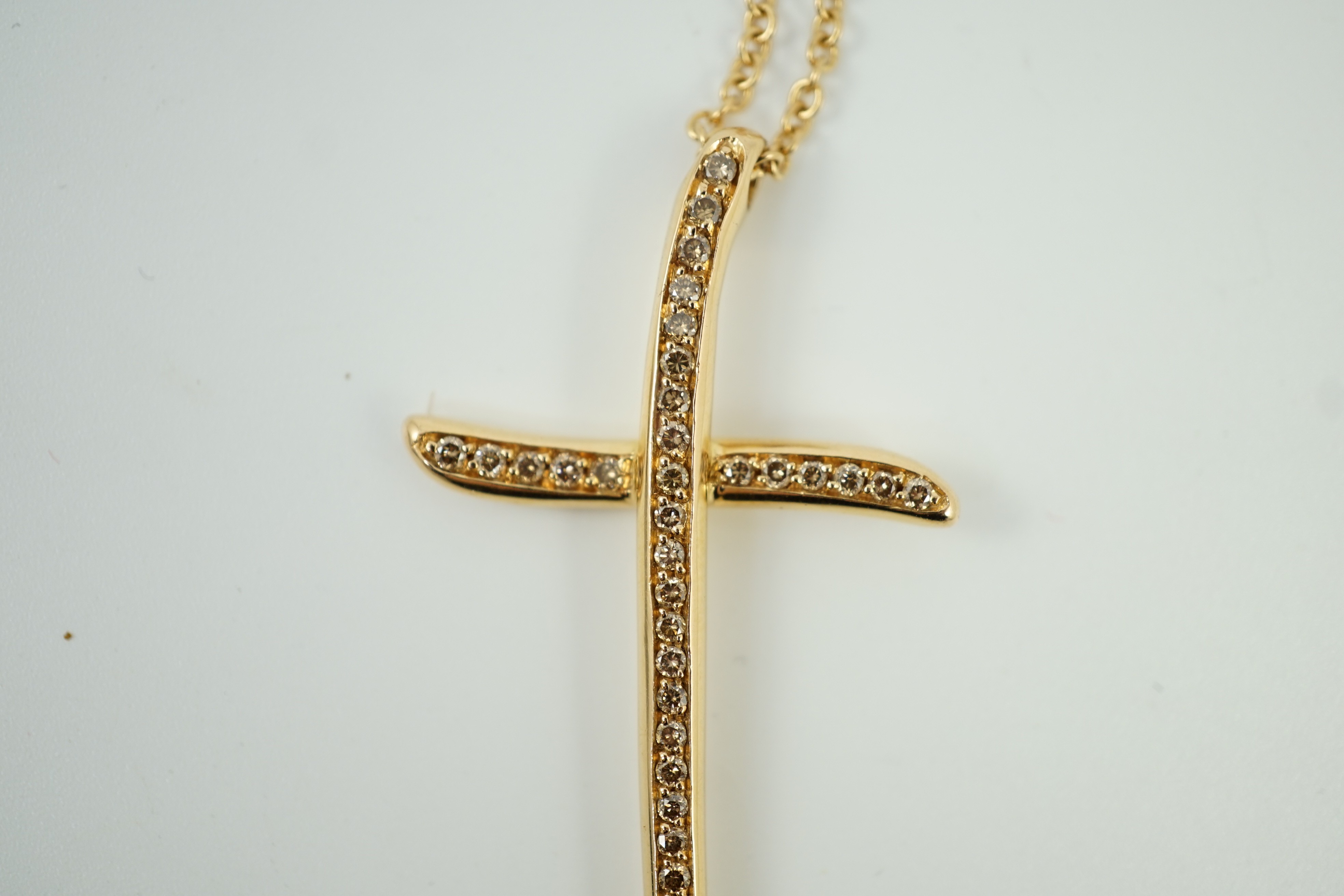 A modern Italian Gavello 750 yellow metal and pave set diamond cross pendant, 77mm, on a 750 yellow metal chain, 40cm, gross weight 14.5 grams.